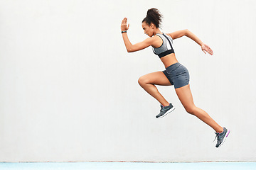 Image showing Woman, fitness and running on mockup for sports in cardio training, workout or healthy exercise. Fit, active or sporty female person or runner exercising for health and wellness on wall mock up space