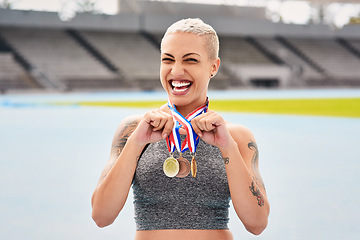 Image showing Portrait, success medals and woman athlete at stadium after winning race or sports event outdoors. Fitness, winner and female runner happy with victory, goals or target achievement on track field.