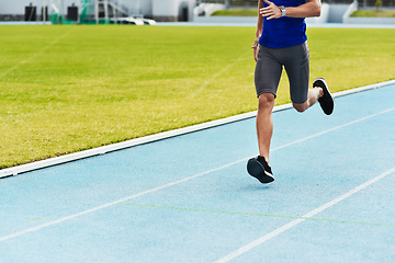 Image showing Man, legs and running on stadium track for fitness, workout or exercise of athlete training outside. Leg of male person or runner exercising in run, athletics or sports competition for healthy cardio