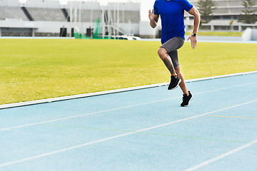 Image showing Man, legs and running on track for fitness, workout or exercise of athlete training at the stadium. Leg of male person or runner exercising in run, athletics or sports competition for healthy cardio