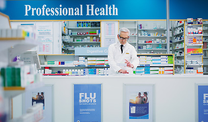 Image showing Pharmacy package, elderly man and chemist reading pharmaceutical, supplements or product info. Typing, store medicine and male pharmacist research supplement prescription information for healthcare