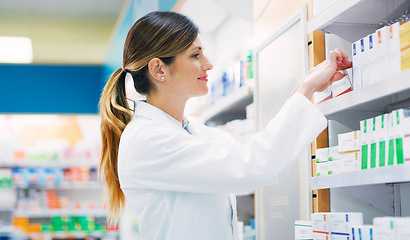 Image showing Pharmacy, product shelf and happy woman, pharmacist or chemist search for pills, supplements or pharmaceutical. Hospital retail dispensary, medicine and medical person fixing box package display