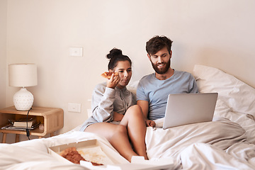 Image showing Couple, pizza and movie on laptop in bed with junk food and streaming series. Eating, computer video and meal in a bedroom at home with man and woman together with bonding and online watching