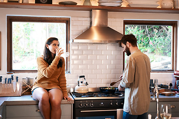 Image showing Cooking, couple and wine in a kitchen at home with food at a stove drinking alcohol. Young woman, man and drinks in a house together making dinner with bonding, love and care for eating a meal