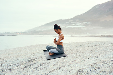 Image showing Yoga, calm meditation and woman on a beach with lotus pose, wellness and fitness. Pilates, sea and female person on sand with peace in nature feeling relax with spiritual and ocean exercise alone