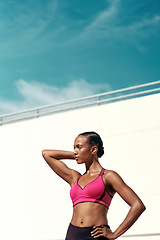 Image showing Sports, fitness and sky, woman with mockup, wall at outdoor gym for health and wellness with muscle power. Workout, exercise and athlete with focus, space and healthy mindset for fit summer goals.