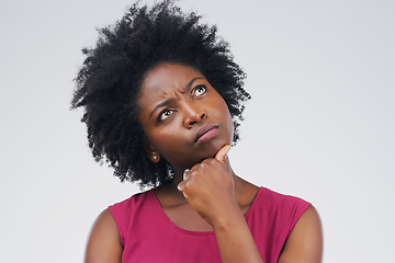 Image showing Black woman, thinking and confused in studio with decision or choice on space pr grey background. Doubt, unsure and African female person contemplating, solution and emoji, puzzled and skeptical
