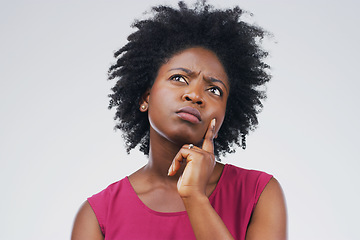 Image showing Confused, thinking and black woman in studio with frown, decision or choice on grey background space. Doubt, suspicious and African female person concerned, unsure or pensive and contemplating