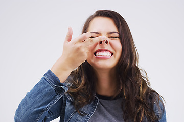 Image showing Smile, funny face and nose with a crazy woman in studio on a white background for carefree humor. Comic, comedy and showing nostrils with a weird young female person feeling playful while joking