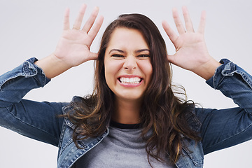 Image showing Portrait, funny face and ears with a crazy woman joking in studio on a white background for humor. Comic, comedy and hands with a happy young female person feeling playful while smiling or having fun