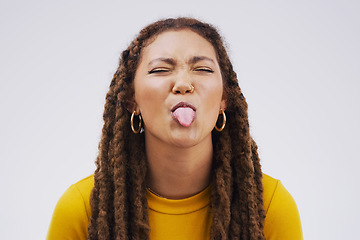 Image showing Portrait, funny face and tongue with a black woman joking in studio on a white background for humor. Comic, comedy and braids on eyes with a playful young female person eyes closed for an emoji