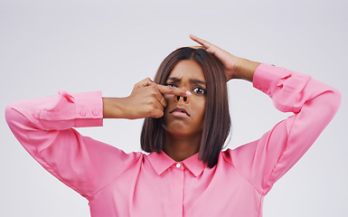 Image showing Portrait, funny face and nose with an indian woman in studio on a gray background looking silly or goofy. Comedy, comic and quirky with a crazy young female person playing indoor for a joke or humor