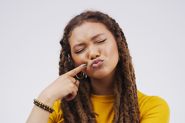 Image showing Finger, funny face and pout with a black woman joking in studio on a white background for humor. Comic, comedy and duckface with a pouting young female person feeling playful while having fun