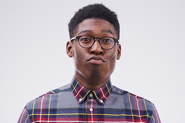 Image showing Funny face, young and portrait of a black man pouting isolated on a white background in a studio. Geek, pout and a face headshot of an African person with glasses as a nerd, goofy and quirky