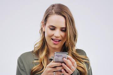 Image showing Phone, surprise and face of woman in studio with smile for social media, internet and chatting online. Communication, white background and female person on smartphone for website, mobile app and text