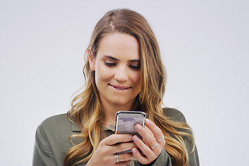 Image showing Phone, online and face of woman in studio with smile for social media, internet and dating mobile app. Communication, white background and female person on smartphone for flirting, chat and texting