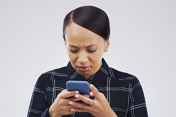 Image showing Confused, phone and woman typing in studio isolated on a white background. Problem, cellphone and female person frustrated on app, fake news or browsing online, social media and glitch, spam or scam.