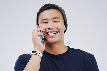 Image showing Phone call, funny and portrait of Asian man talking in studio isolated on white background. Cellphone, laughing and face of male person in communication, speaking or discussion, comedy or comic meme.