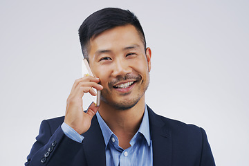 Image showing Phone call, smile and portrait of Asian man talking in studio isolated on a white background. Cellphone, happy and face of business person in communication, speaking or discussion, network and chat.