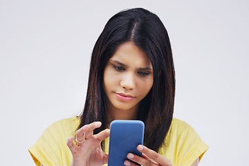 Image showing Serious, phone and woman typing in studio isolated on white background for social media. Mobile, cellphone and female person texting, networking or email, web scroll or browsing online messaging app.