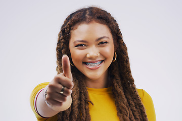 Image showing Young woman, studio and portrait of thumbs up with agreement, vote or hand review with happiness by background. African model or sign for opinion, yes or thank you for motivation, winning and success