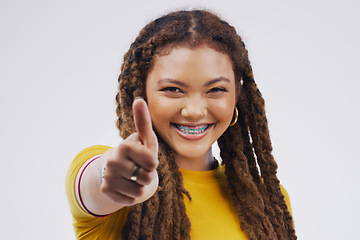 Image showing Woman, studio portrait and smile with thumbs up for agreement, vote or hand for review with happiness by background. Girl, model and sign for opinion, yes or thank you for motivation, win and success