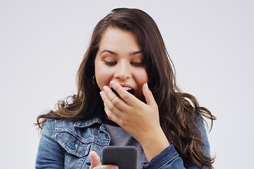 Image showing Woman, surprise and phone in shock for winning, prize or good news against a white studio background. Shocked or surprised female person reading on mobile smartphone in wow for lottery competition