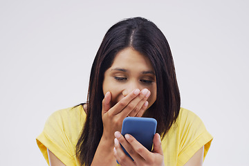 Image showing Woman, surprise and phone for prize, good news or winner against a white studio background. Shocked, surprised or excited female person reading on mobile smartphone for lottery winning, wow or bonus