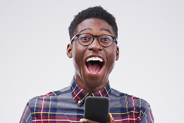 Image showing Black man, surprise and phone for winning, prize or good news against a white studio background. Shocked or surprised African male person on mobile smartphone of winner in wow for lottery competition