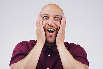 Image showing Shock, surprise and portrait of a man in studio with excited, wow or omg facial expression. Happy, smile and face of male model with good news, success or achievement to celebrate by gray background.