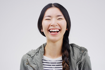 Image showing Thats hilarious. Female youth, laugh and face with happiness with studio with freedom and positivity. Woman, student and funny with portrait, free with cheerful mood with smile in casual clothes.