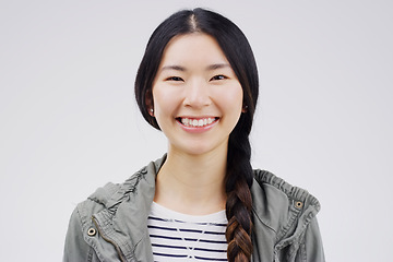 Image showing Woman, portrait and asian with smile with studio white background is joyful with confidence. Female smiling, face and happiness with empowerment in China for excited youth with casual outfit.