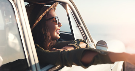 Image showing Road trip, window and happy with a woman in a car for travel, freedom or a joy ride as a tourist on the coast. Nature, sunset and relax with a young female traveler taking a drive for adventure