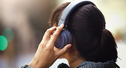 Image showing Woman with headphones in city, back view and listen to music, freedom and technology outdoor. Mockup space, podcast or radio streaming with female person in urban street and audio playlist