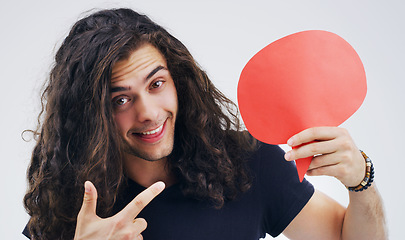 Image showing Man, speech bubble and pointing in studio portrait for smile, opinion or social media by white background. Gen z guy, poster or paper sign for vote, review or mockup with point for idea, news or chat