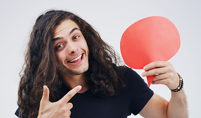 Image showing Man, speech bubble and point in studio portrait with smile, opinion or social media by white background. Gen z guy, poster or paper sign for vote, review and mockup with promo for ideas, news or chat