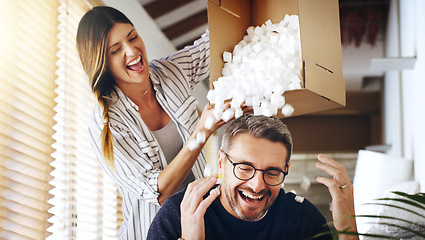 Image showing Moving house, real estate and box with a crazy married couple having fun while playing in their new home together. Property, comic or foam with a playful husband and wife joking in the living room