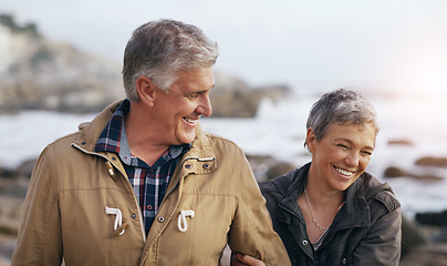 Image showing Senior couple, laugh and beach walk outdoor with smile from marriage and love. Happy, elderly people and bonding by a ocean and sea on holiday with travel and walking on vacation in retirement