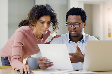 Image showing Couple, document and finance for debt, bills or planning expenses together in the kitchen at home. Serious African man and woman working on paperwork in financial crisis, mortgage or investment plan