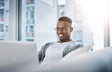 Image showing Home, man and laptop working on sofa or elearning, remote study or distance learning and online studying with internet communication. Black student, happy on computer in apartment or living room