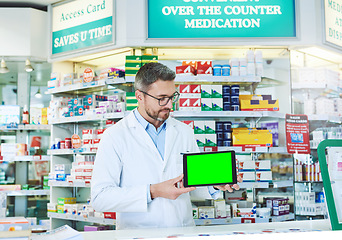 Image showing Man, pharmacist and tablet with green screen with health, store and mockup with pharmaceutical promo on app. Mature pharma expert, digital touchscreen and space with chromakey for mock up in shop