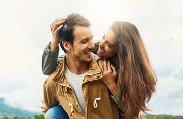 Image showing Playful, love and piggyback with couple in nature for weekend, smile and bonding. Happiness, relax and care with man carrying woman on countryside date for spring, vacation and travel