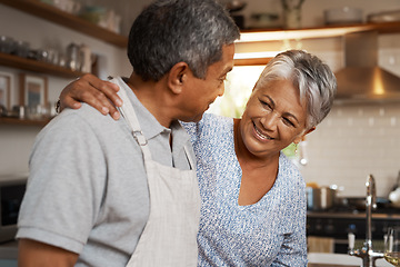 Image showing Kitchen, happiness and old man with woman, embrace and healthy marriage bonding in home for dinner. Love, help and cooking, senior couple with smile, hug in apartment and happy time in retirement.