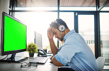 Image showing Businessman, call center and headache with green screen computer in burnout, stress or overworked at office. Man consultant agent with bad head pain or anxiety with mockup chromakey at workplace