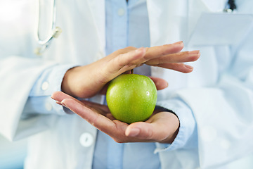 Image showing Hands, doctor and nutritionist with apple for nutrition, healthy diet and wellness. Medical professional, hand and woman with fruit for vitamin c, healthcare or natural food for vegan health benefits