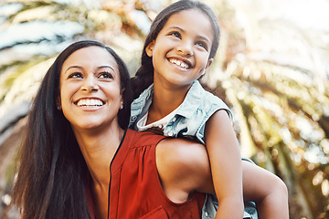 Image showing Happy, outdoor and mother giving her child piggyback ride in the garden of the backyard of their home. Happiness, smile and young woman or mom playing and having fun with her girl kid at family house