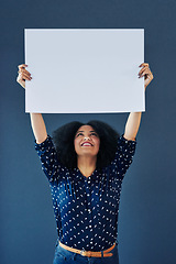 Image showing Mockup, poster and happy woman in studio with banner for news, social media or advertising on blue background. Space, billboard and female person with paper, news and branding promotion or launch