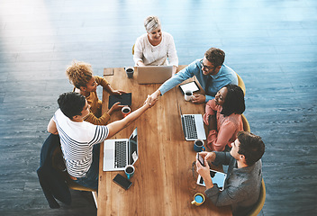 Image showing Handshake, above and business people in a meeting for a deal, onboarding and welcome. Happy, interview and corporate employees shaking hands for thank you, support or partnership in group discussion