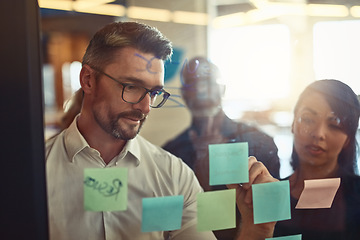 Image showing Businessman, writing and team planning in strategy, brainstorming or schedule tasks at the office. Man DEO in leadership, presentation or training staff in project plan or meeting at workplace