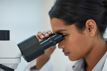 Image showing Science, analysis and scientist with a microscope in lab for discovery, experiment or project. Medical research, biotechnology and woman researcher working with equipment in pharmaceutical laboratory